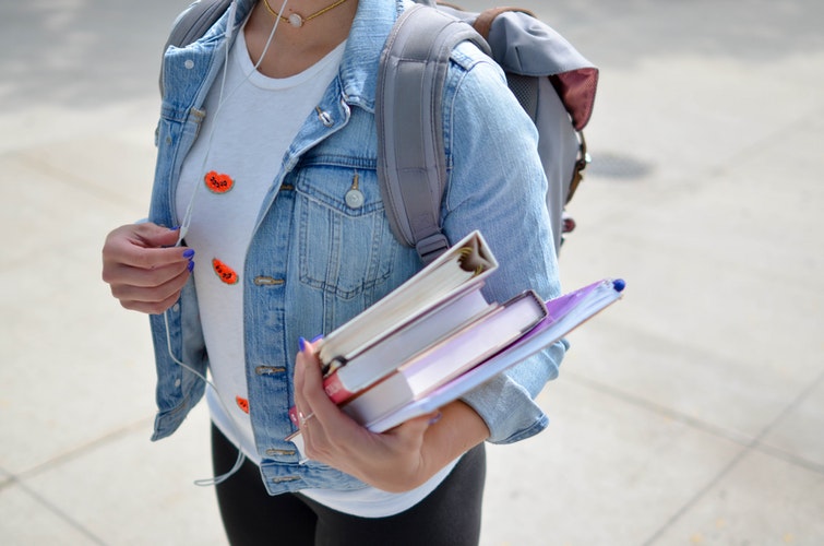 A student walking and carrying books
